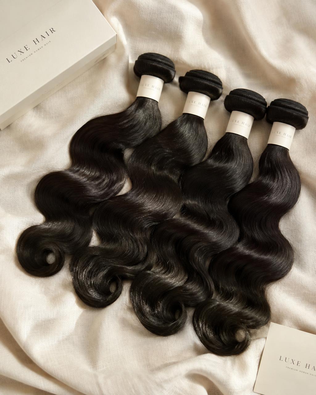 Bundles of raw body wave human hair extensions