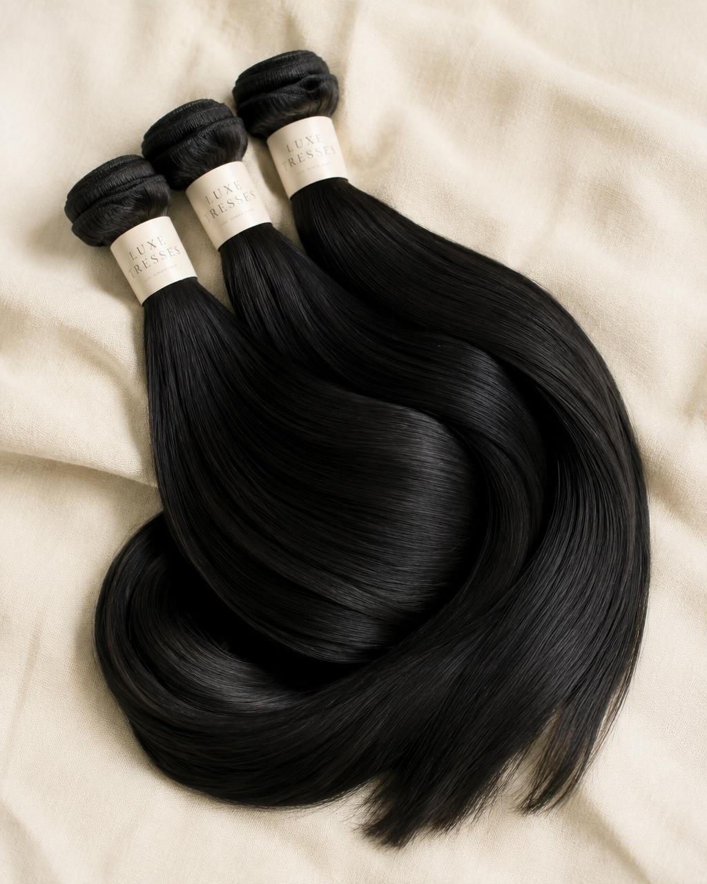 Bundle of raw straight black human hair extensions